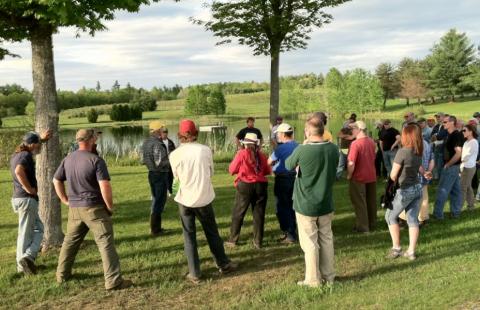Field specialist presenting to a group of farmers