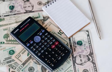 Image of calculator notepad and money 