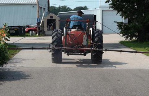 Man riding Boom Sprayer