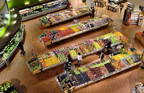 Grocery store layout of fresh fruits and vegetables.