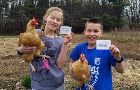 4-H siblings hold up chickens