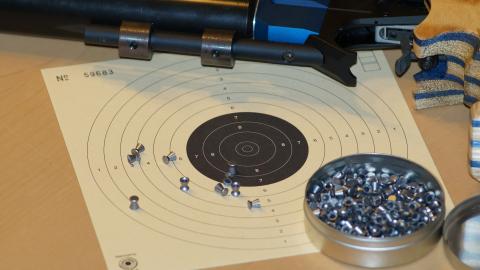 Picture of a shooting target and air rifle ammonition.