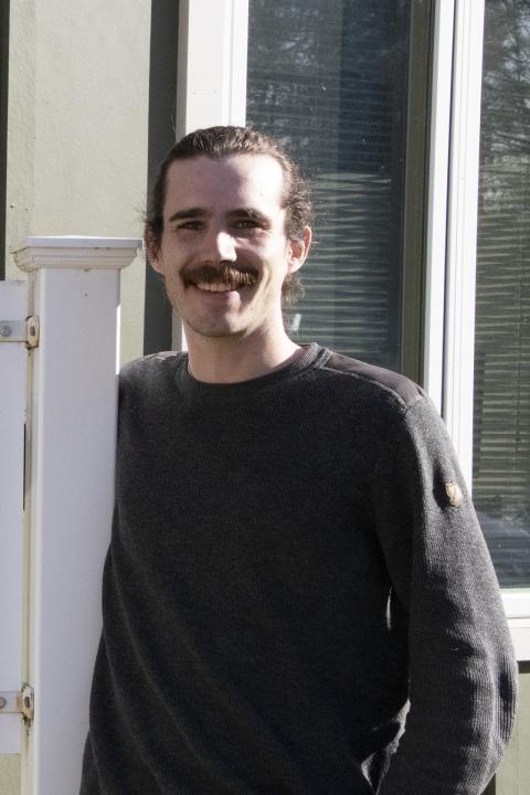 Will Hastings standing next to Coos County Extension sign